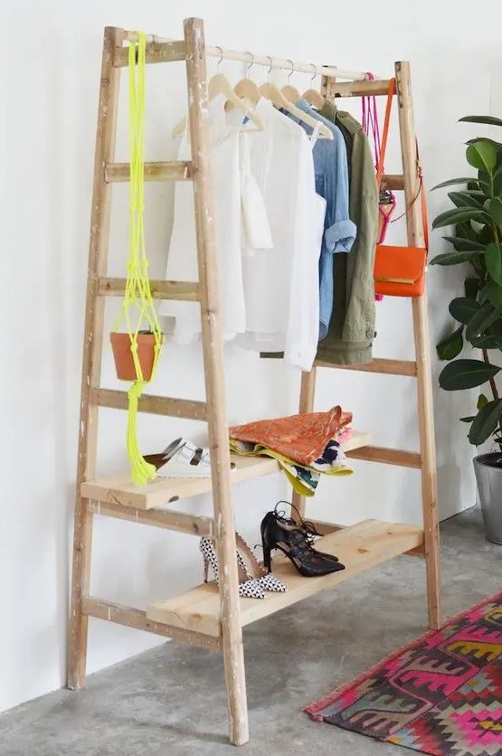a comfy clothes and shoe rack made of a couple of ladders and some wooden planks, easy to DIY and very functional