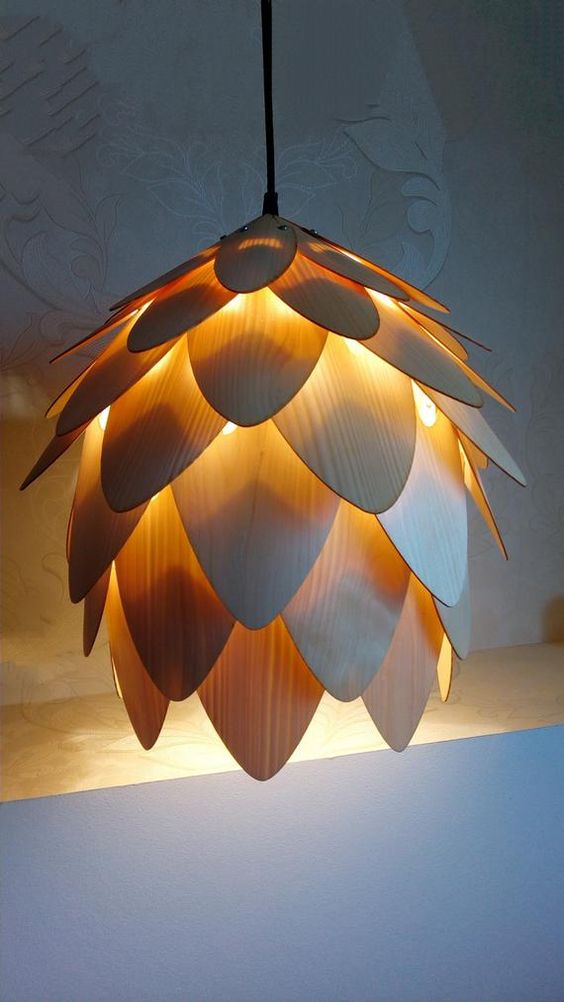 a creative pendant lamp of plywood that imitates a flower is a cool idea for a modern space