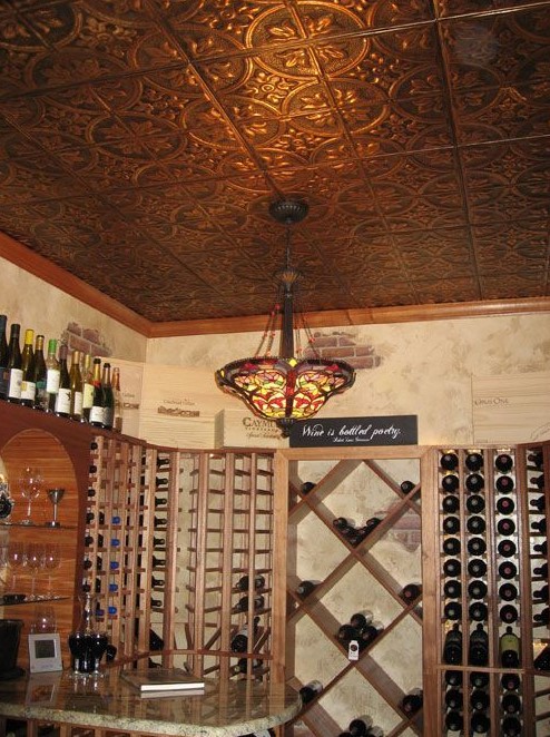 a home wine cellar spruced up with a pressed tin ceiling that gives a chic and vintage feel to the space