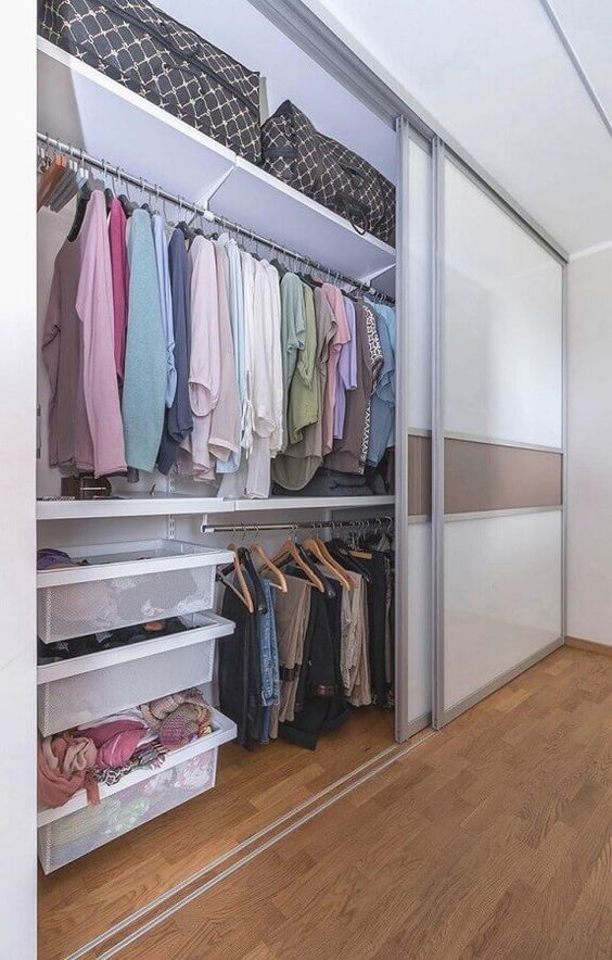 a large closet with glass sliding doors and lots of shelves, baskets and drawers is a stylish idea for any bedroom and it gives a lot of storage