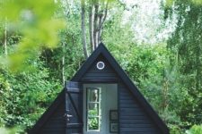 a minimalist triangular cottage-inspired she shed can accommodate a bedroom, place a bed with lots of pillows there