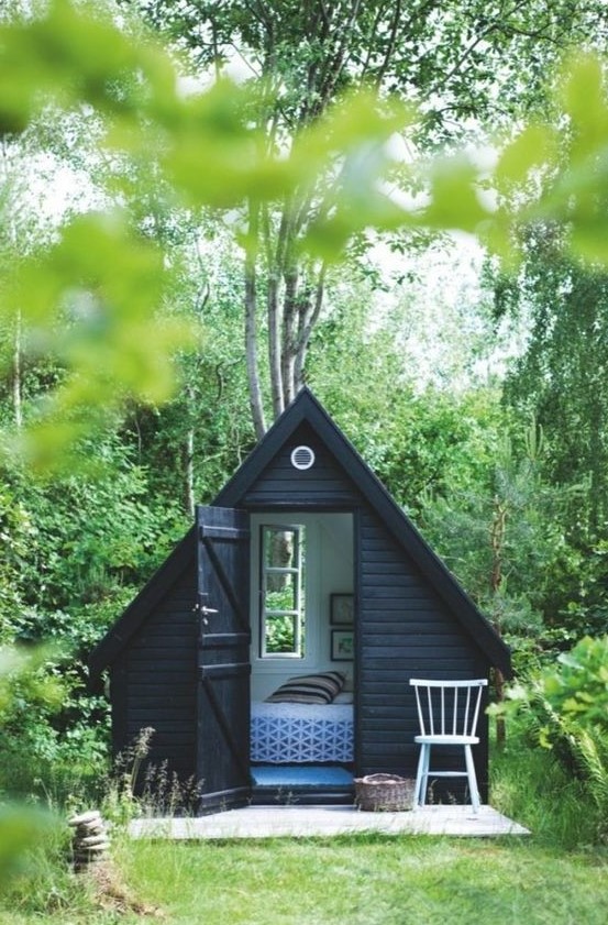 a minimalist triangular cottage inspired she shed can accommodate a bedroom, place a bed with lots of pillows there