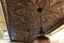 a pressed tin metal ceiling shows off a beautiful vintage pattern that adds an exquisite touch to the space