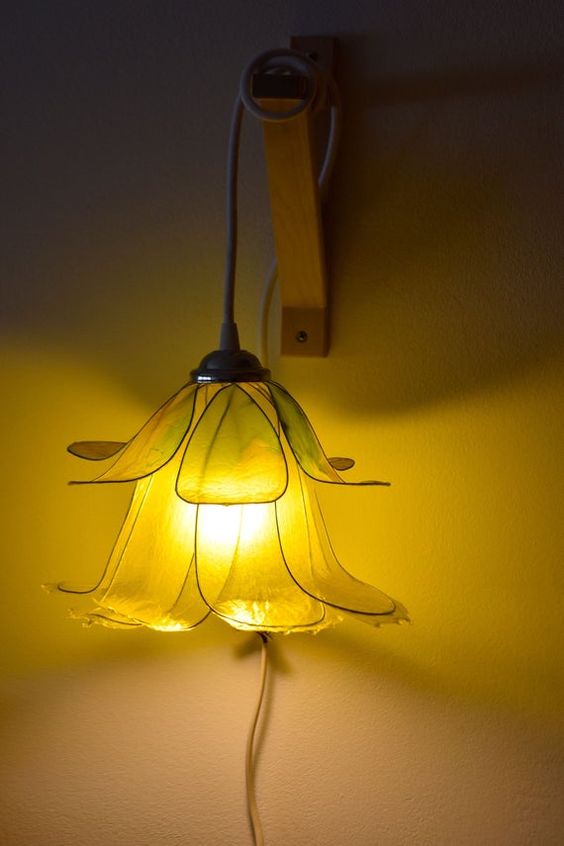 a pretty mustard-color pendant lamp shaped as a flower with long petals is a stylish idea
