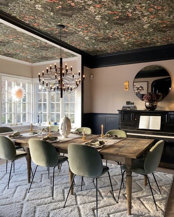 a refined dining room with a dark floral wallpaper ceiling that echoes with the chairs in color