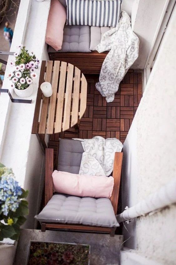 a small stained folding table is a lovely idea for a tiny balcony, you may serve some food and drink here and hide it when not in need