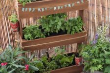 a vertical tiered wooden planter with greenery won’t take much floor space but will refresh your little space a lot and make it cooler