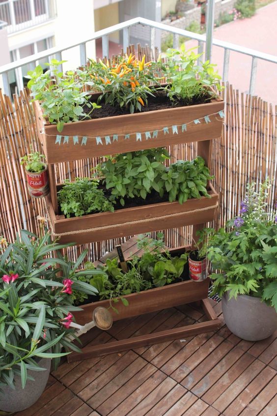 a vertical tiered wooden planter with greenery won't take much floor space but will refresh your little space a lot and make it cooler