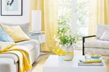 a vivacious living room with yellow curtains, a rug and some pillows feels sun-filled and very bright