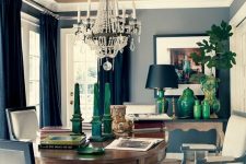 an elegant dining room with refined furniture, a sophisticated chandelier and a gold ceiling