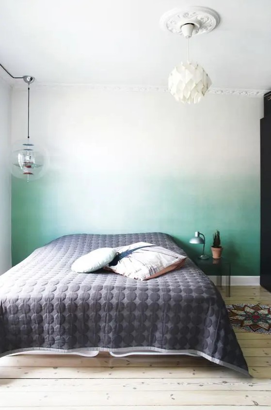 an ombre green statement wall behind the headboard is a peaceful yet catchy touch of color to the bedroom