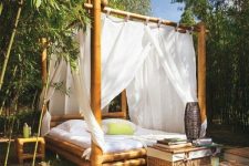 an outdoor tropical bedroom of bamboo, with canopies, woven chests for storage and a candle lantern is amazing