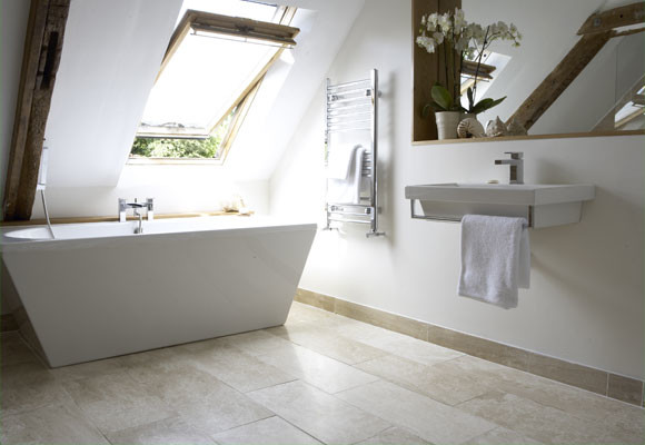 a minimalist attic bathroom with a sculptural tub, a small floating sink, a mirror and some wood in decor  (Anne Webster Designs Pty Ltd)