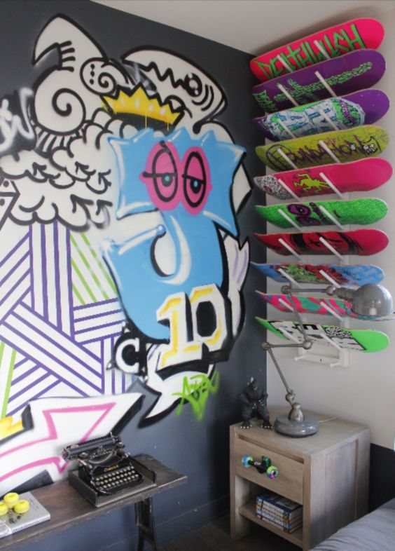 a bold graffiti on the wall, super bold graffiti boards and a stained nightstnad for a super colorful teenager room