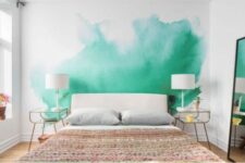 a bold green watercolor wall makes the bedroom colorful and vivacious
