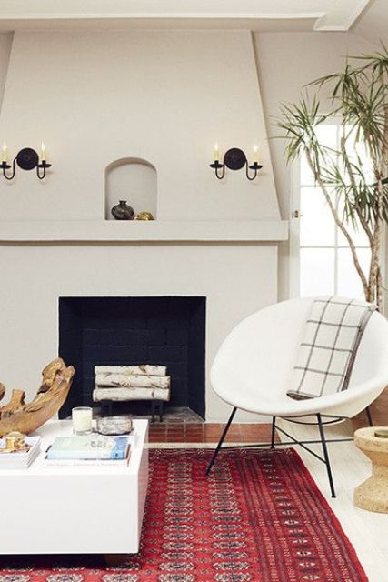 a bright burgundy rug with patterns for adding a fall mood to the neutrla living room