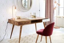 a chic refined burgundy velvet chair on wooden legs will add a fall feel and mid-century modern elegance