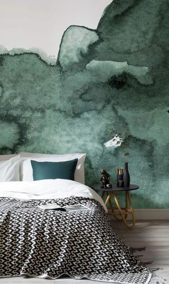 a dark green watercolor accent wall is a great statement in this bedroom, add a matching piece like a pillow here