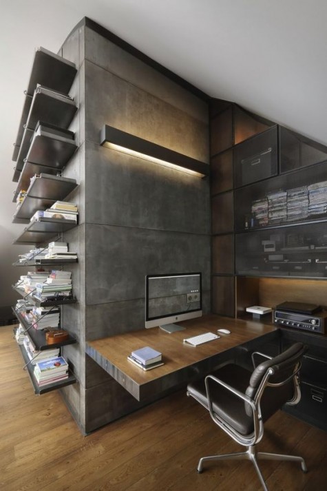 a minimalist industrial home office with concrete walls, a plywood wall-mounted desk, a leather chair and some metal shelves