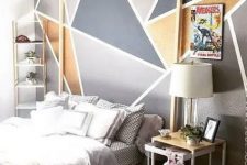 a trendy bedroom with a geometric wall
