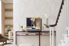 a neutral wall with a chaotic geometric pattern is a cool idea to add an eye-catchy touch and an interesting look to the space