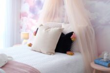 a lovely girl’s bedroom with a watercolor accent wall
