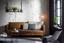 a simple industrial living room with shabby walls, hairpin leg coffee tables and industrial floor lamps