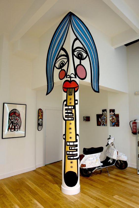 a unique entryway done in white to become a perfect backdrop for colorful graffiti and graffiti artworks is wow
