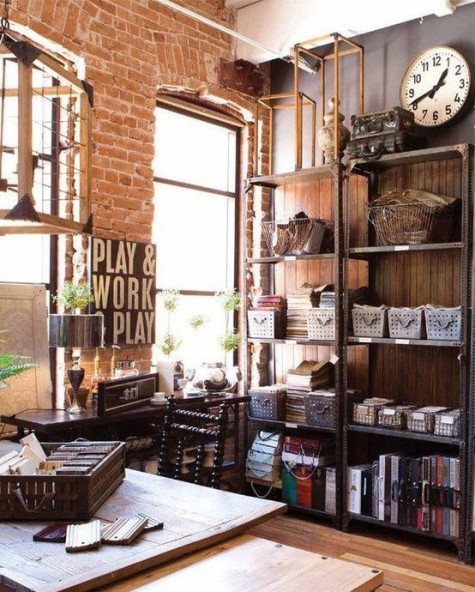 a vintage industrial home office with metal shelving units, a wooden desk and chair, some lamps and a vintage clock