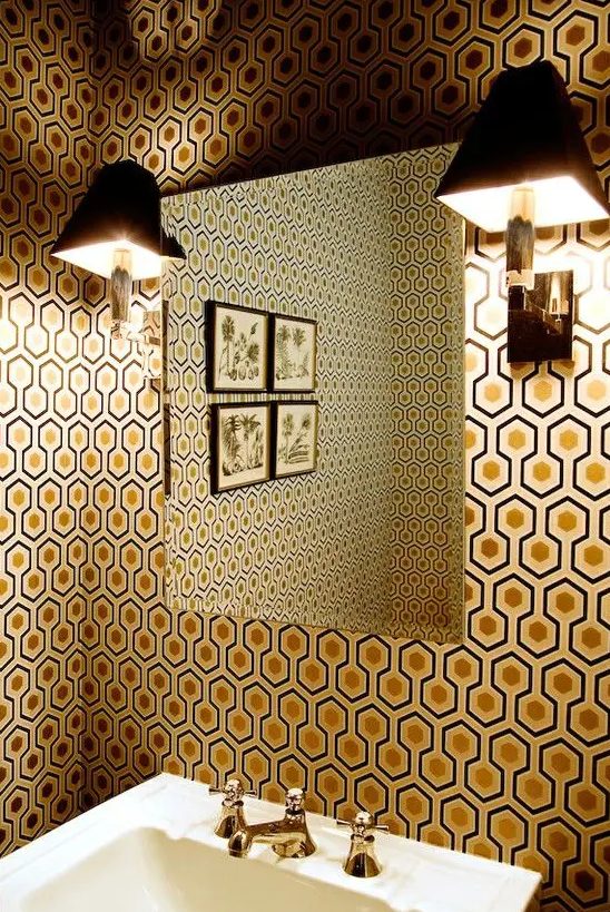 an elegant vintage inspired bathroom decorated with hexagon print with gold inside wallpaper that brings chic to the space