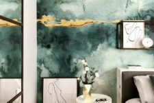 an eye-catchy bedroom with a green watercolor wall with touches of gold, a bed with neutral bedding, artwork, a side table