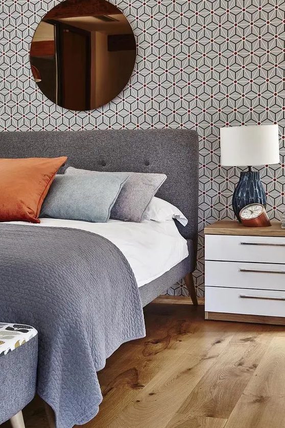 bold, geometric wallpaper and mid century modern furniture create a cool themed look in this bedroom