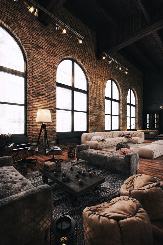 brick walls of a former stock, wooden floors, leather ottomans and floor lamps with a retro feel
