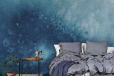 such blue watercolor wallpaper gives the bedroom a slight seaside feel