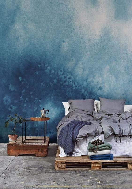 such blue watercolor wallpaper gives the bedroom a slight seaside feel