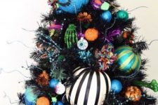 a bold Halloween tree in black, with colorful ornaments, skeleton hands, eyeballs and beads is fun