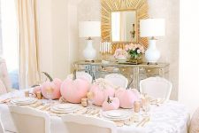 a chic glam Halloween table setting with pink velvet pumpkins, gold touches and white plates