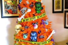 a color block Halloween tree in orange and yellow, with skeletons, eyeballs, bones and masks is crazy