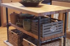 a creative industrial kitchen island on casters built of butcherblock pieces and black piping is a very functional and practical idea