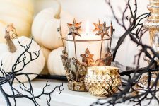 a glam celestial candleholder, a gold one, spooky branches and white pumpkins for chic Halloween decor