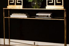 a gold console table with a shelf, matching gold table lamps will give a strong glam feel to the room