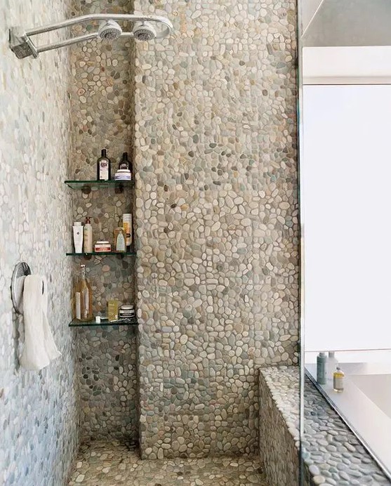 a shower space fully clad with pebble tiles will make you feel as if you are taking shower outdoors