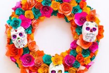 a super colorful paper flower wreath with painted sugar skulls is a chic piece that can be DIYed