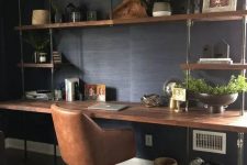 an oversized open storage unit with a built-in industrial desk of metal pipes and wood is a whole very practical working station