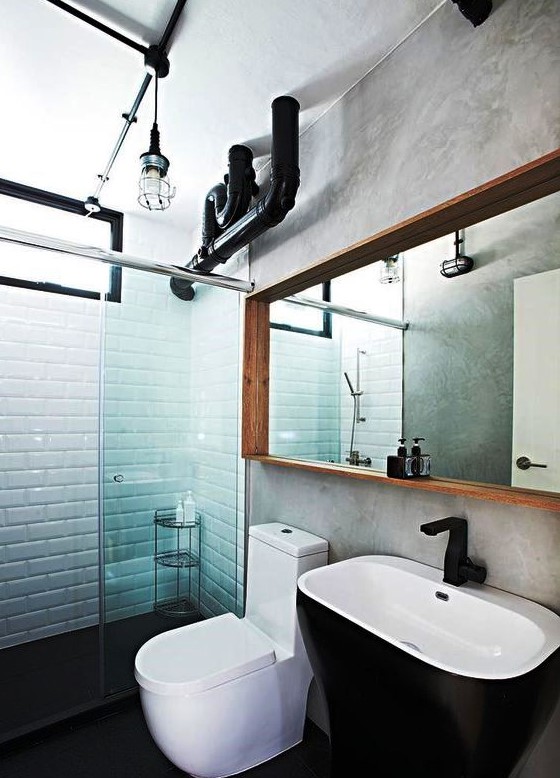 exposed metal pipes in the bathroom and industrial lamps make the space look cooler