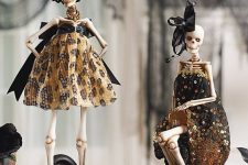 glam ghoulish decor – skeleton in designer dresses and with large bows – is great for Halloween