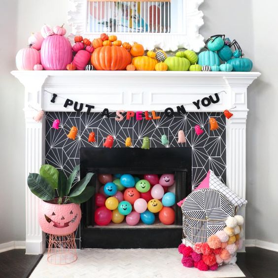 rainbow pumpkins, colorful balloons, bright tassle ghosts and a garland for Halloween