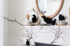 a Halloween mantel with branches, a vase with pampas grass, blackbirds and antlers is a lovely idea for Halloween