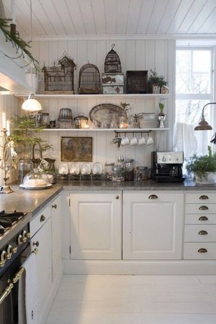 a Scandinavian cottage kitchen with shaker cabinets and a planked floor, planked walls and a ceiling, open shelves and lamps