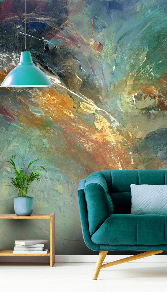 a bold abstract wall mural in greens, blues and bold matches the color scheme of the room and brings a colorful touch